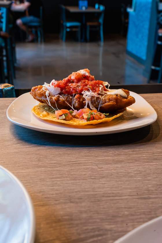 A loaded tostada on a table in the Papa Juan's Northridge dining room